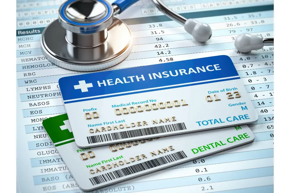 Health Insurance cards total and dental care with stethscope.