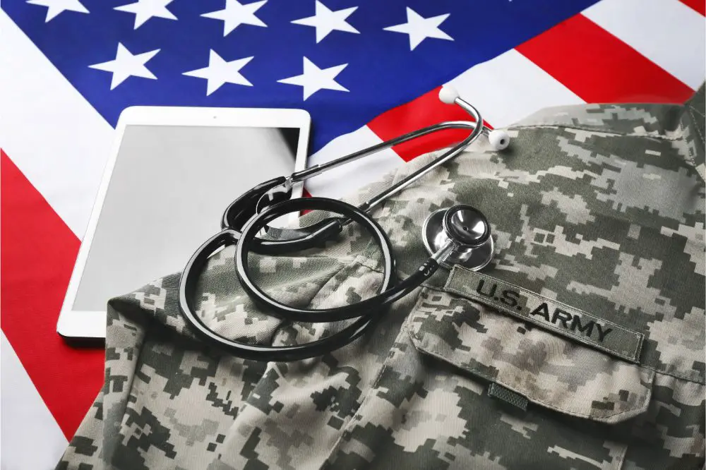 Stethoscope, military uniform and tablet on American national flag