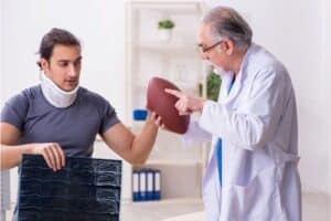 Young american footbal player visiting old doctor