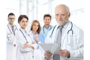 Portrait of aged doctor with medical residents